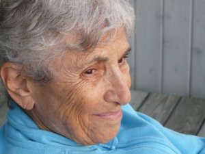 Here is a picture of my mom with her hearing aid in. You can just make out the wire that is going into her ear canal. While the hearing aid is hard to see, my very observant 6-yr old (at the time) niece told my mother, "you put your earrings on wrong today" when she first saw the aids.